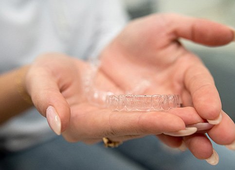 Patient holding clear aligners