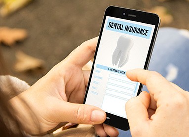 Patient looking at dental insurance form on phone