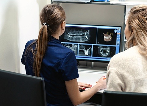 Dental team members reviewing digital dental x-rays