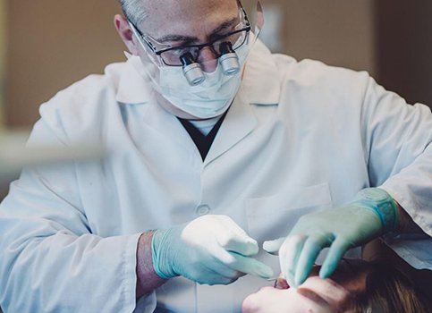 Dentist using microscopes to view teeth