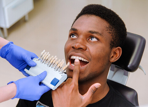 man pointing to his tooth