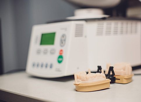 Set of dentures being repaired at in office dental lab