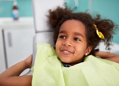Smiling young girl at dental office for children's dentistry visit