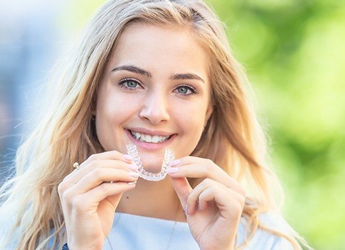 Young woman placing her Invisalign tray