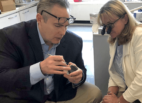 Doctor Volker and student looking at dental smile mold