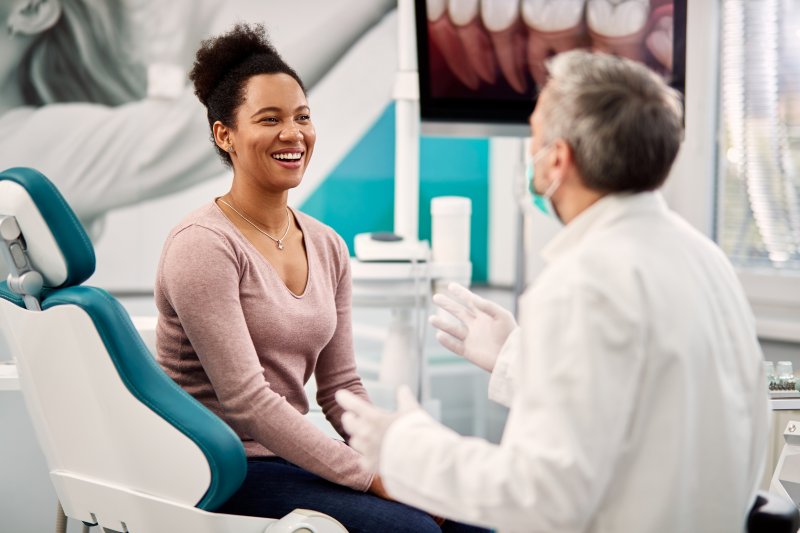 woman asking questions during dental implant consultation in Sunnyside