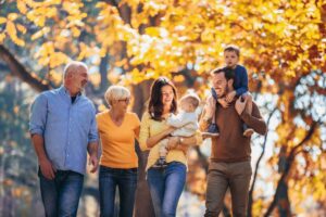 Three generations of a family smiling and walking